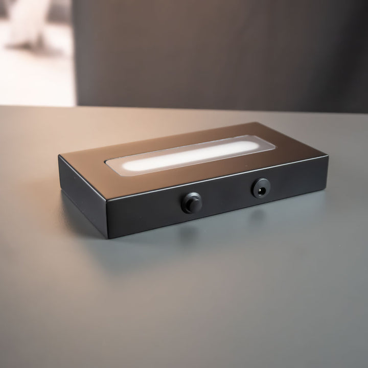 Matte black luxury light base 9x16 cm with light on, available as an add-on for the iceberg