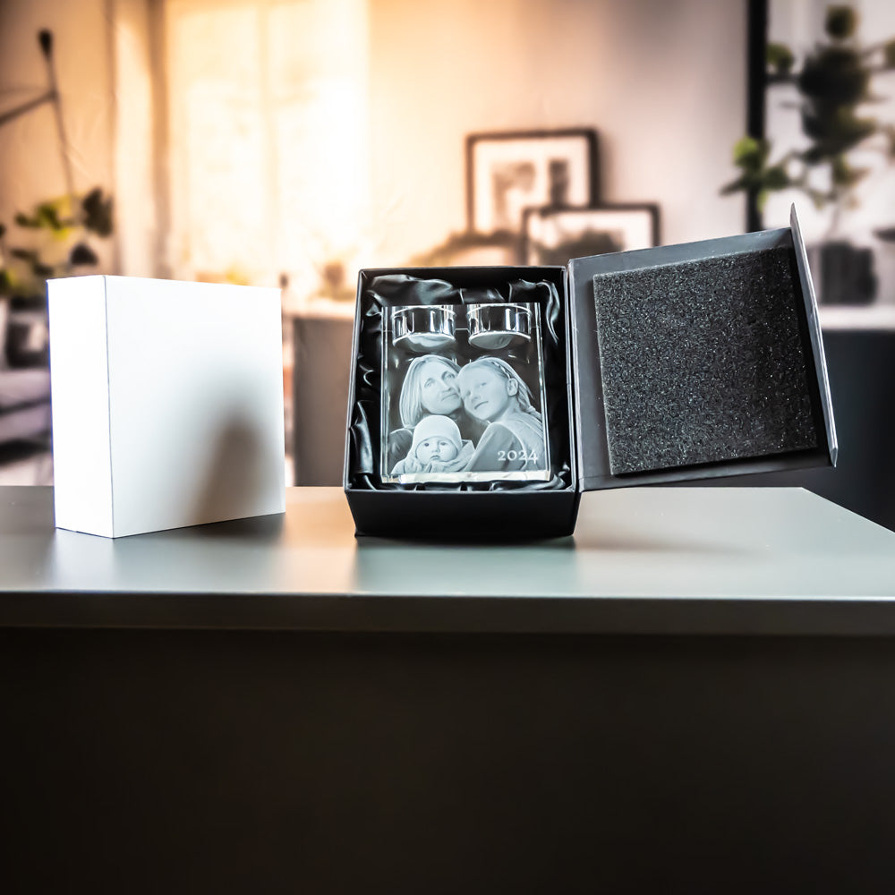 Holder for 2 tea lights in an open black gift box next to a white outer box