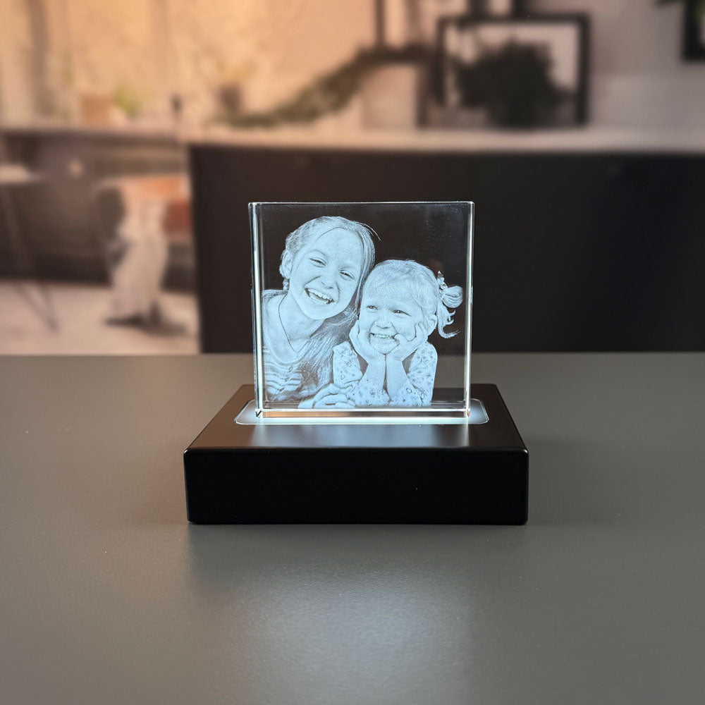 Glass block with two engraved girls lit by a luxury light base