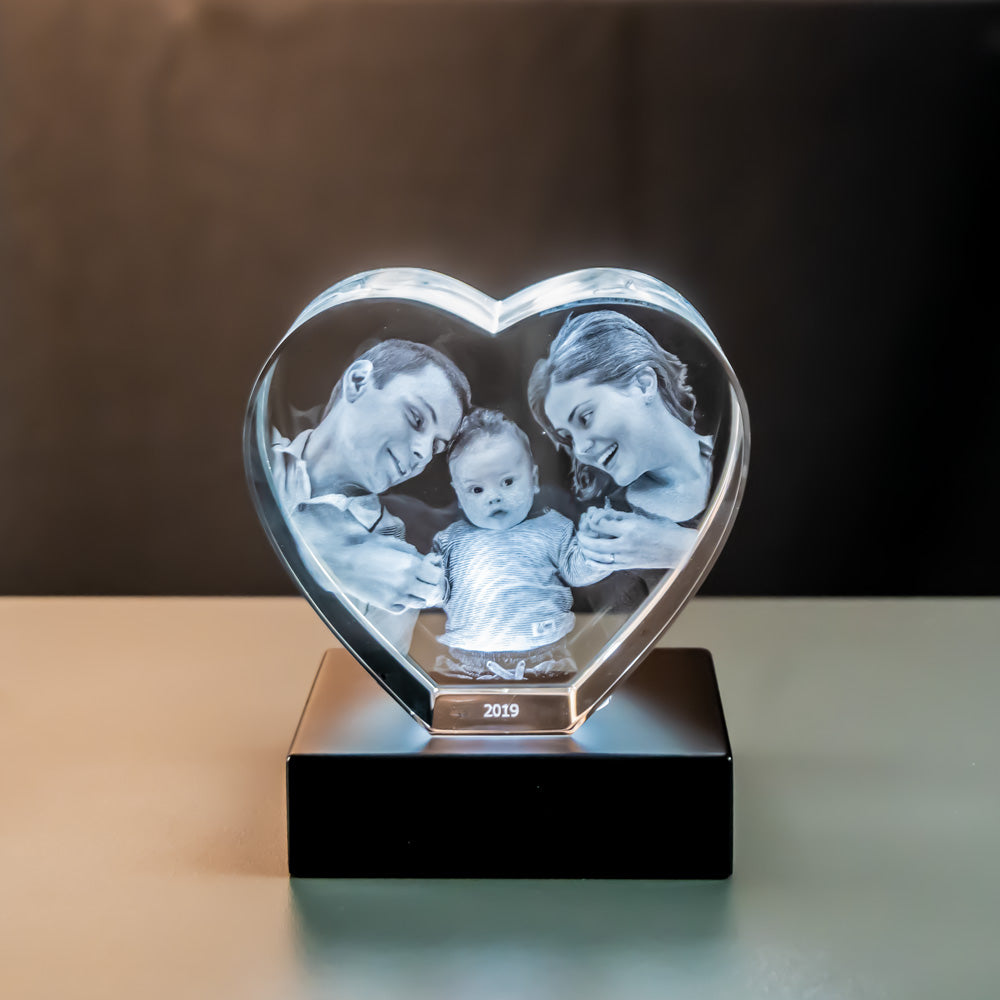 Glass heart with engraved family lit by a matte black luxury light base