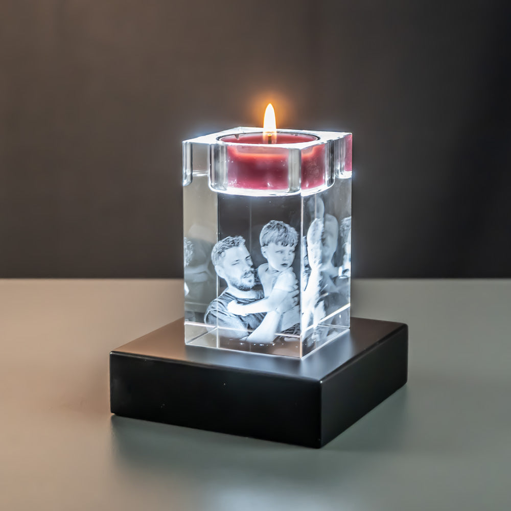 Tea light holder with father and son seen at an angle on a lit luxury light base