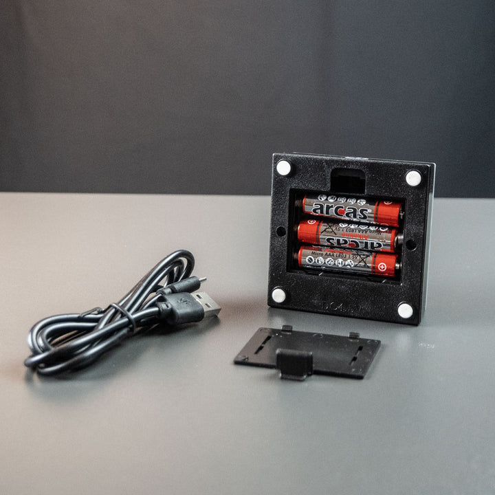 Black battery light base with battery compartment and USB cable