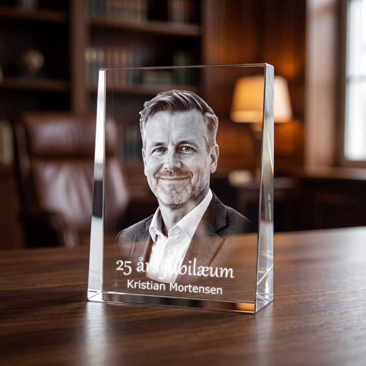 Crystal glass prism award with 3D laser-engraved portrait of a man and text for a 25th anniversary