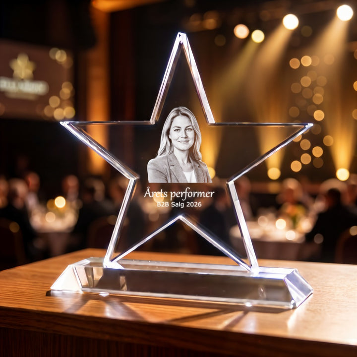 Star-shaped crystal glass award with laser-engraved portrait of a woman and text about performer of the year