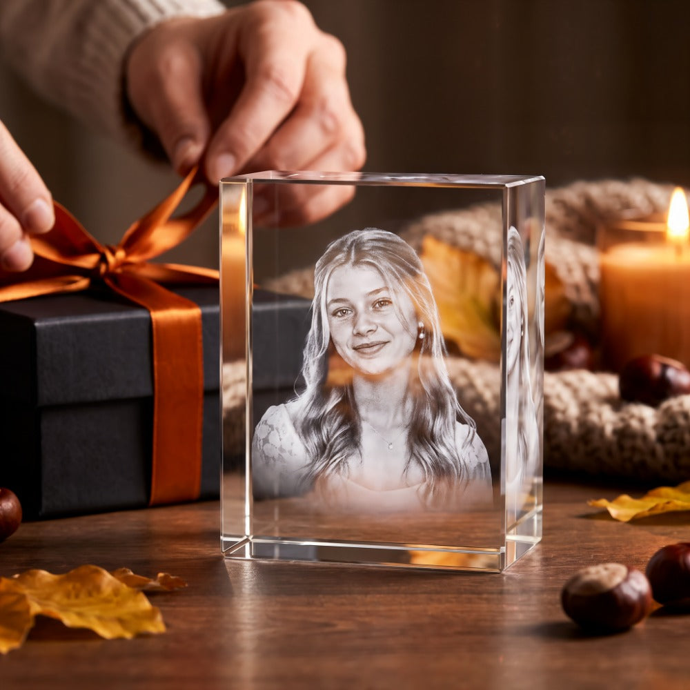 Rectangular crystal glass block with 3D laser-engraved portrait of a young woman by a gift box