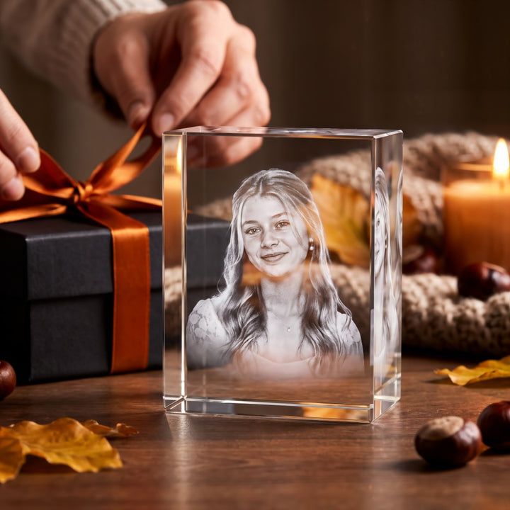 Rectangular crystal glass block with 3D laser-engraved portrait of a young woman by a gift box