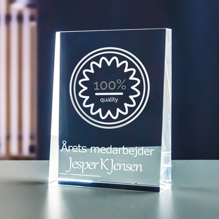 Crystal glass prism award with 2D-engraved logo and the text Employee of the year