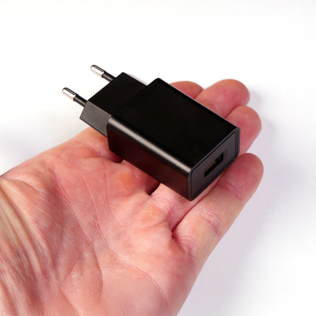 USB power supply for multi light base held in the hand to show the size