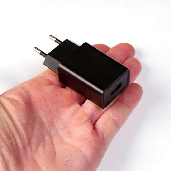 USB power supply for multi light base held in the hand to show the size