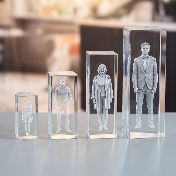 Tall rectangular glass blocks in four sizes with 3D-engraved people