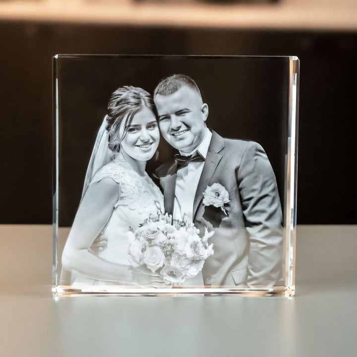 Large square glass block with bride and groom seen straight from the front