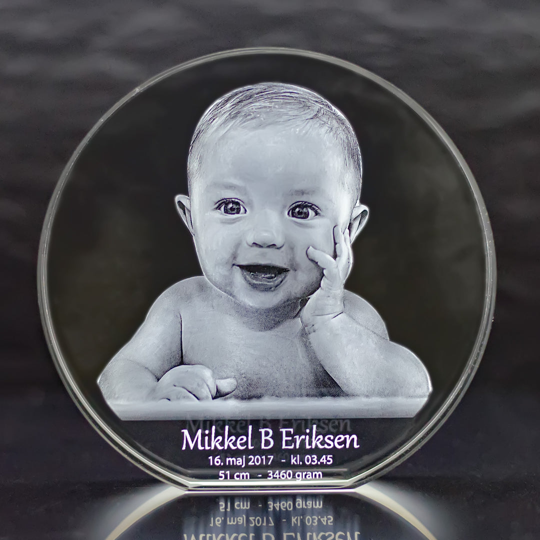 Close-up of round glass block with engraved baby, name and birth details