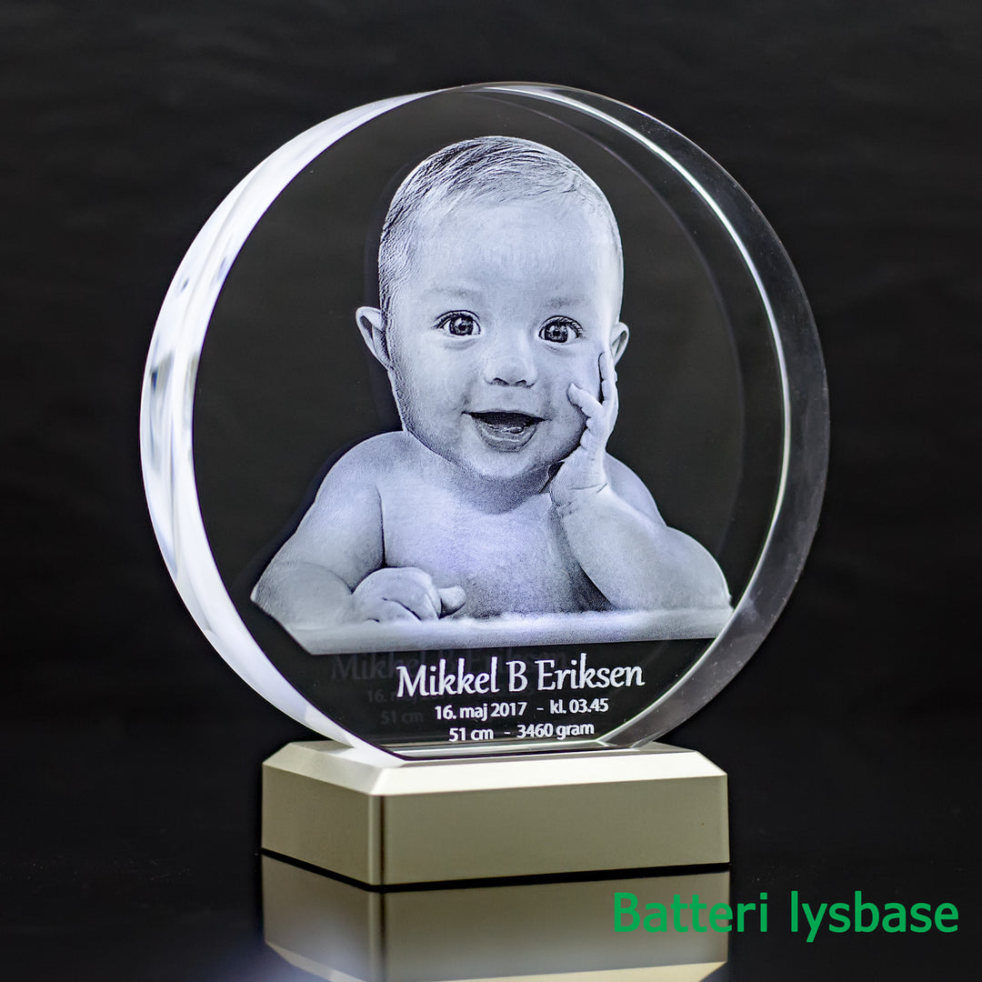 Round glass block with 3D laser-engraved smiling baby on a battery light base