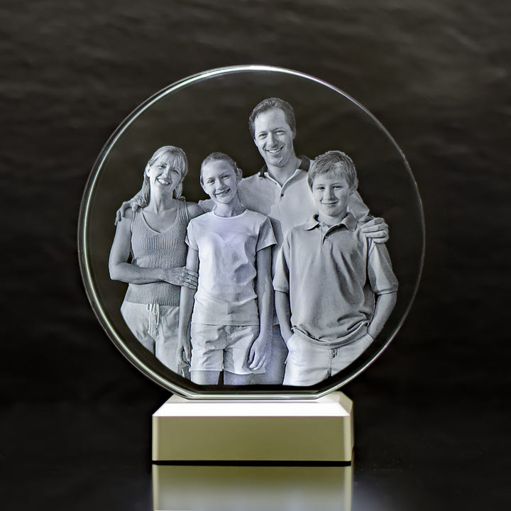 Round glass block with 3D laser-engraved family of four on a light base