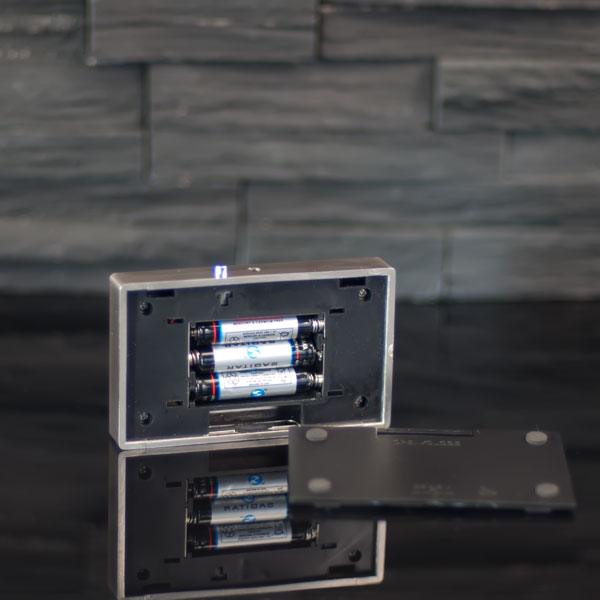 Open battery compartment with 3 AAA batteries in battery light base 6x10 cm