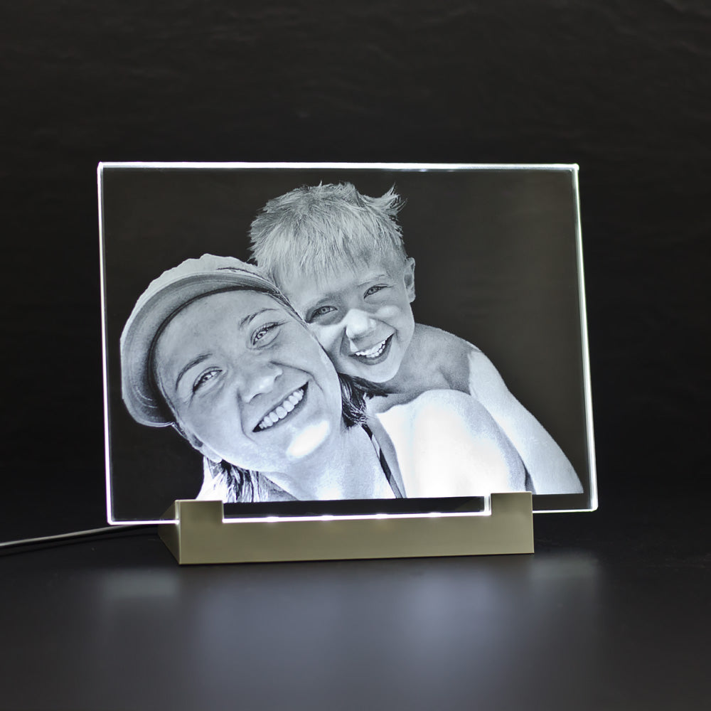 Crystal glass photo frame with 2D laser-engraved photo of father and son on a light stand
