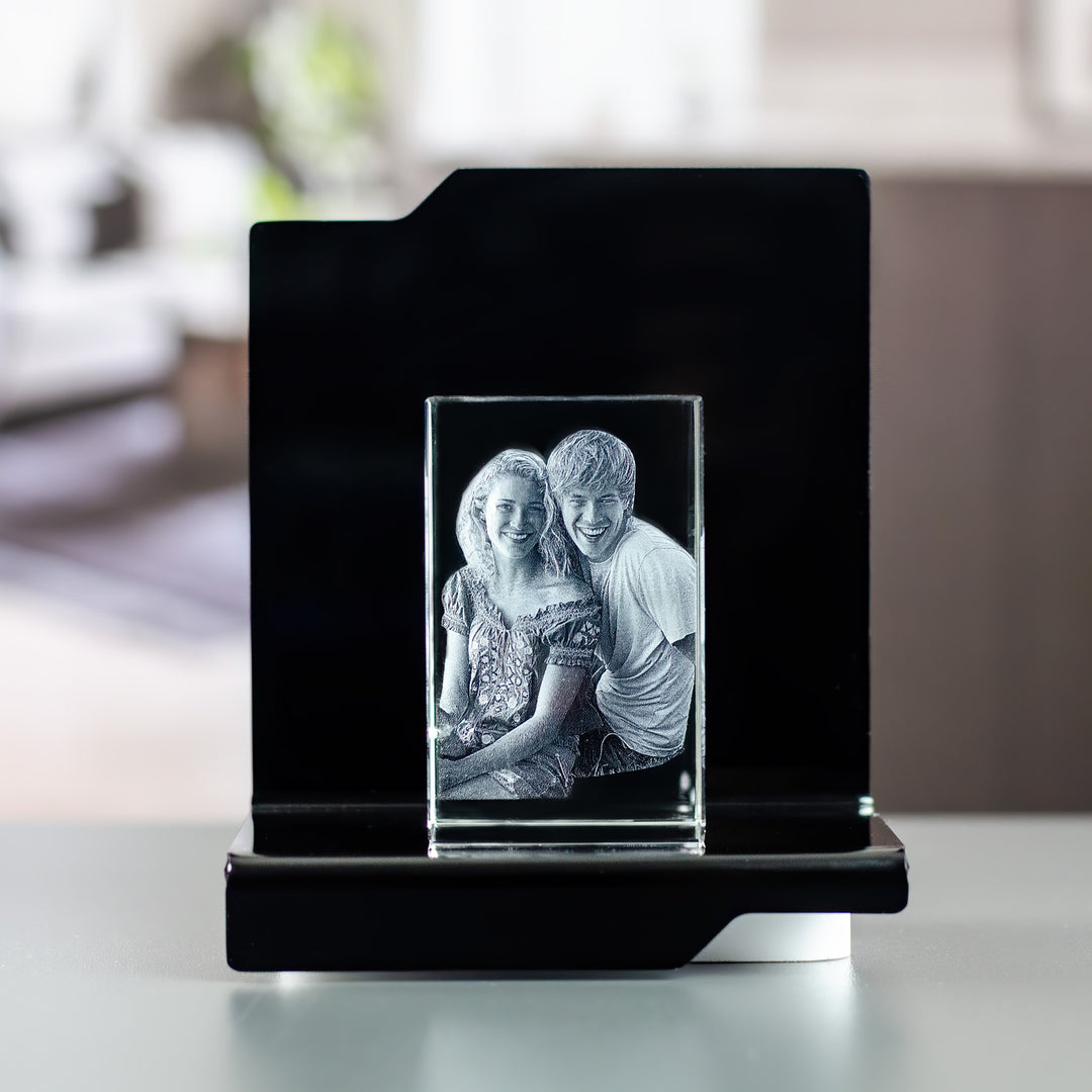 Small rectangular glass block with engraved couple on a black Opera light base